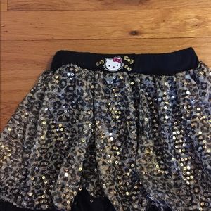 A gold and black sequined Hello Kitty skirt.